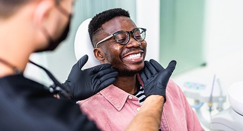 Dentist looking at patient's smile