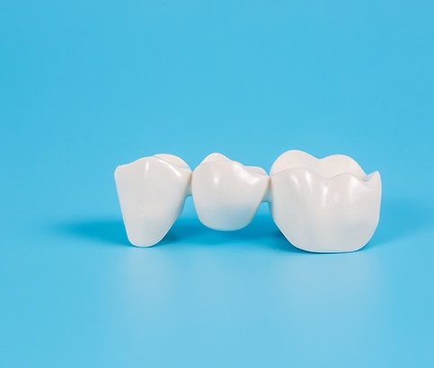 Closeup of a dental bridge with light blue background